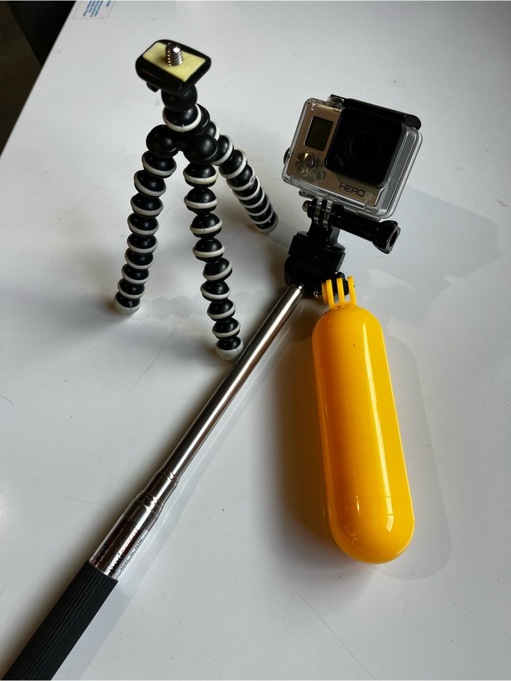 GoPro HERO 3 with Yellow Floating Hand Grip and Black/White Flexible Tripod